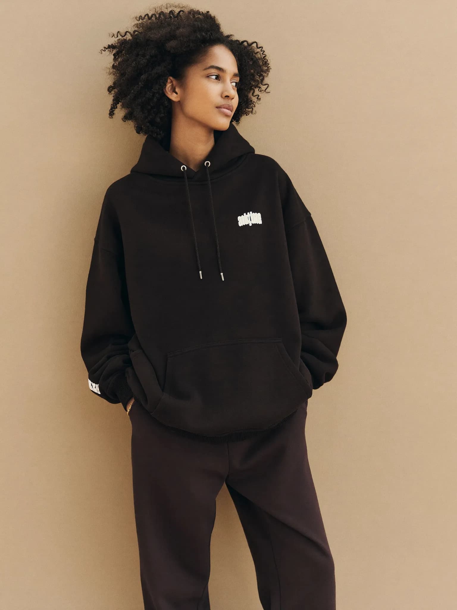 Model wearing the Black Heavyweight Pullover Hoodie.