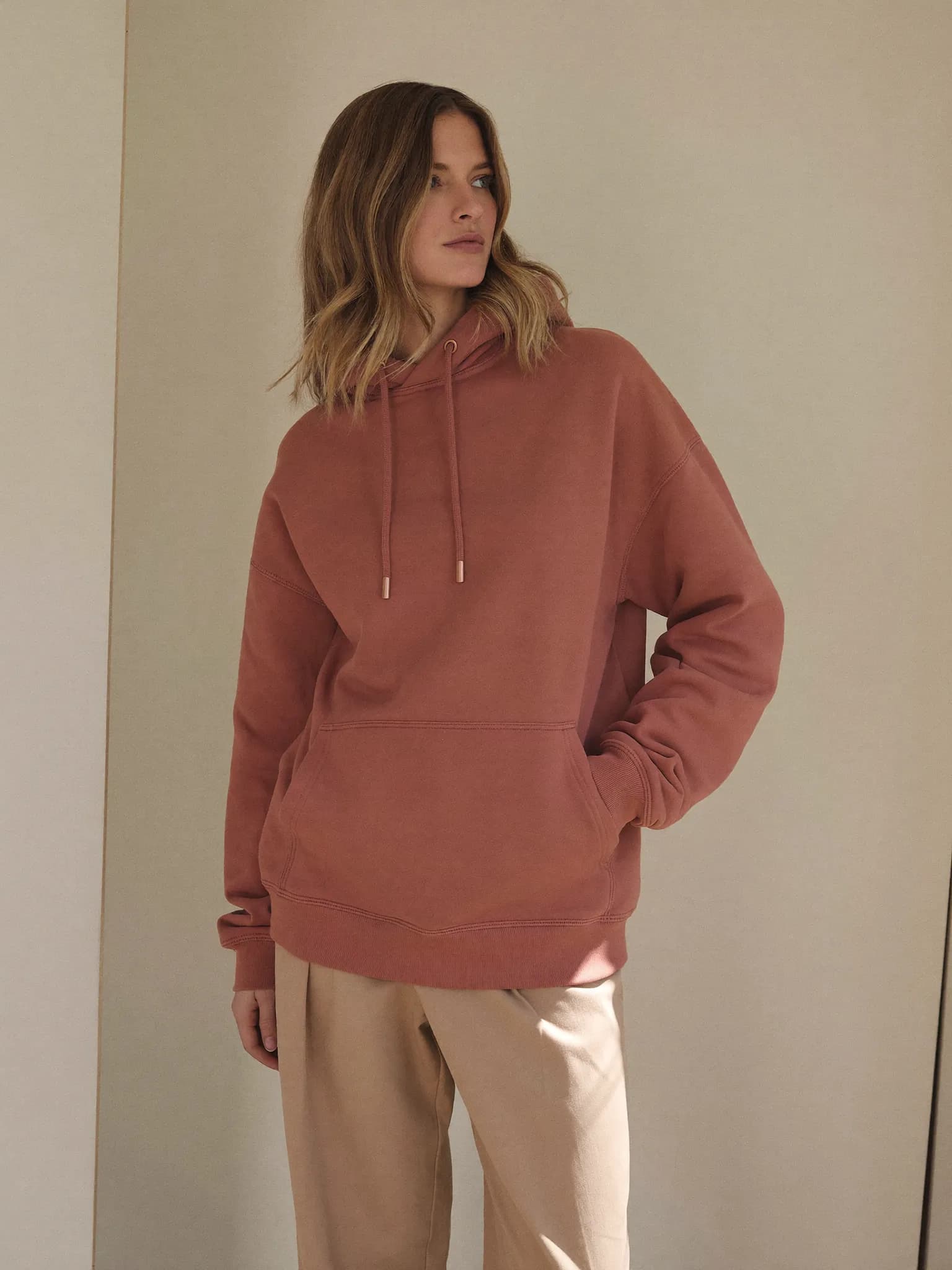 Model wearing the Dusty Rose Heavyweight Pullover Hoodie.