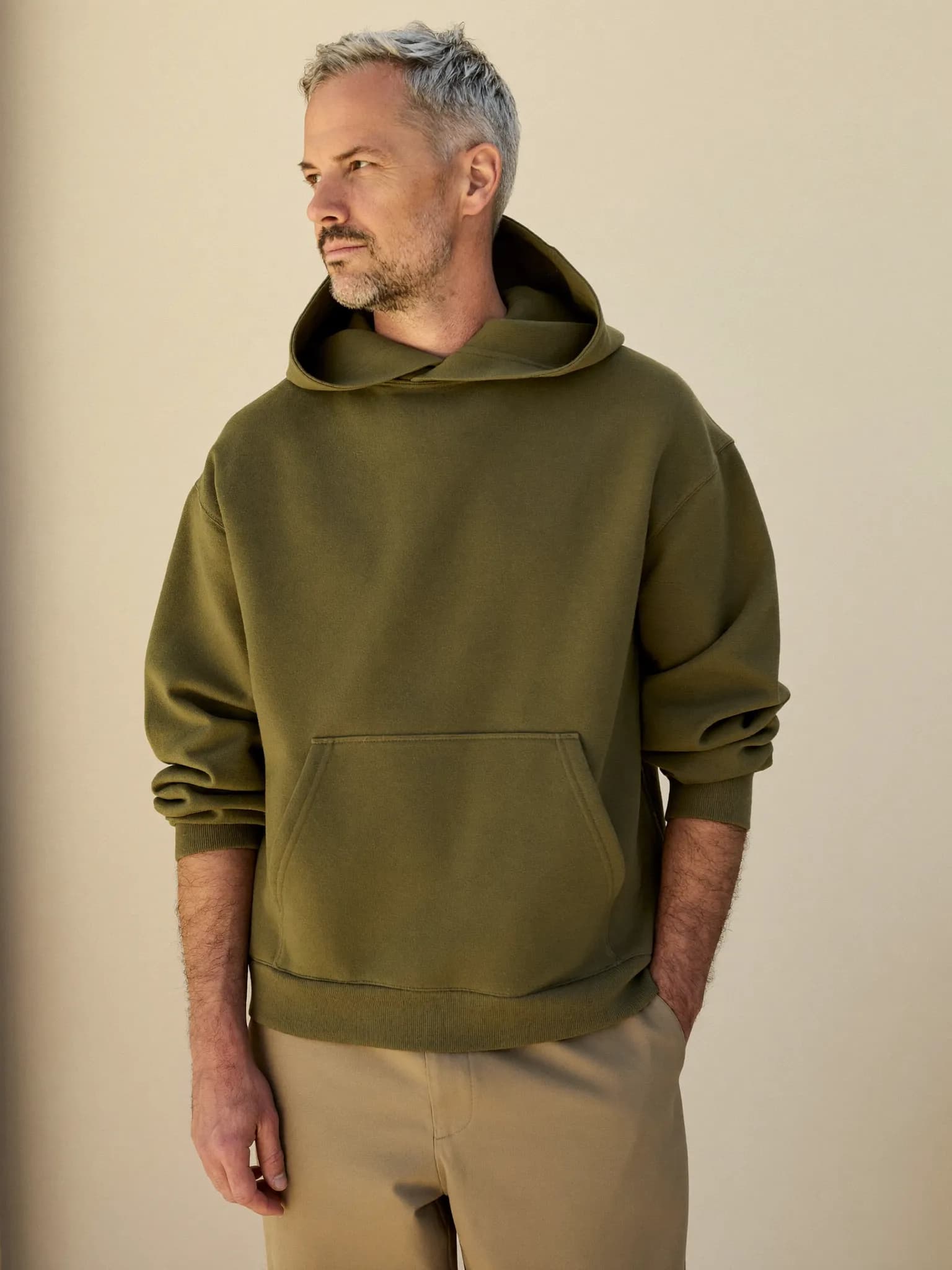 Model wearing the Olive Heavyweight Pullover Hoodie.