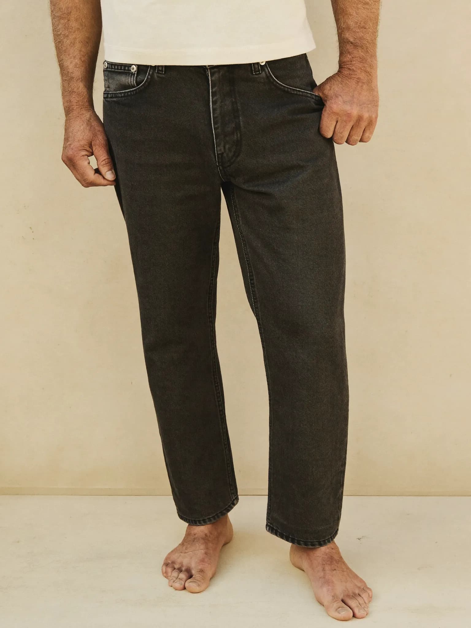 Model wearing the Washed Black Slim Tapered Jeans.